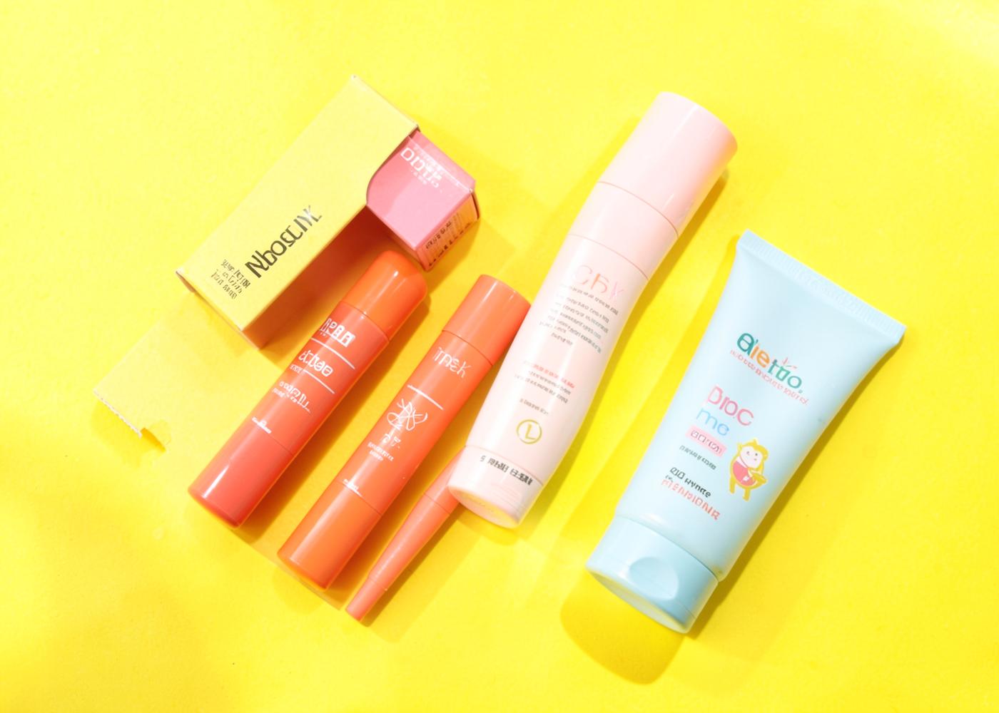 Colourful clean beauty products on a sunny yellow background